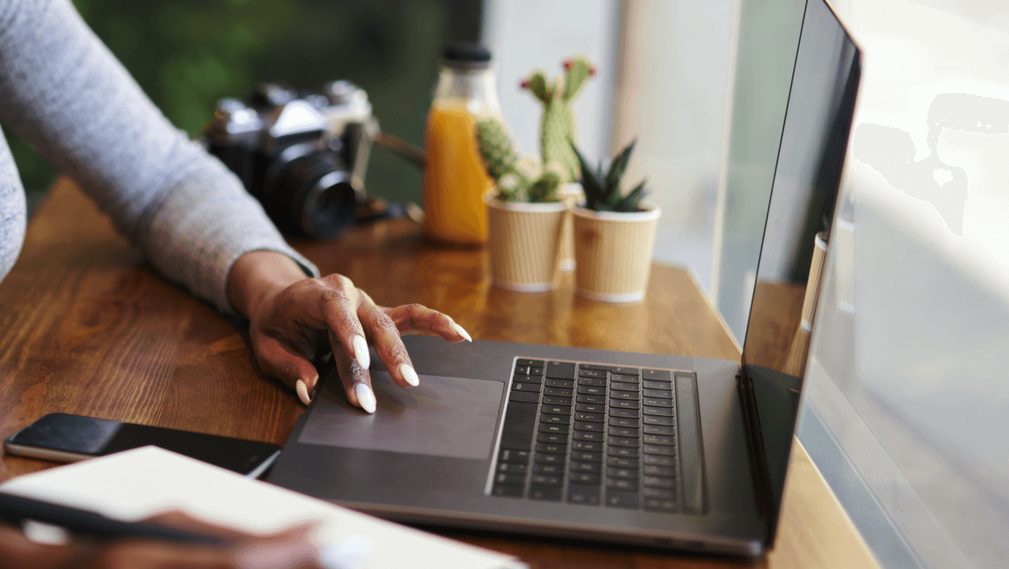 Photo of hand on laptop touchpad