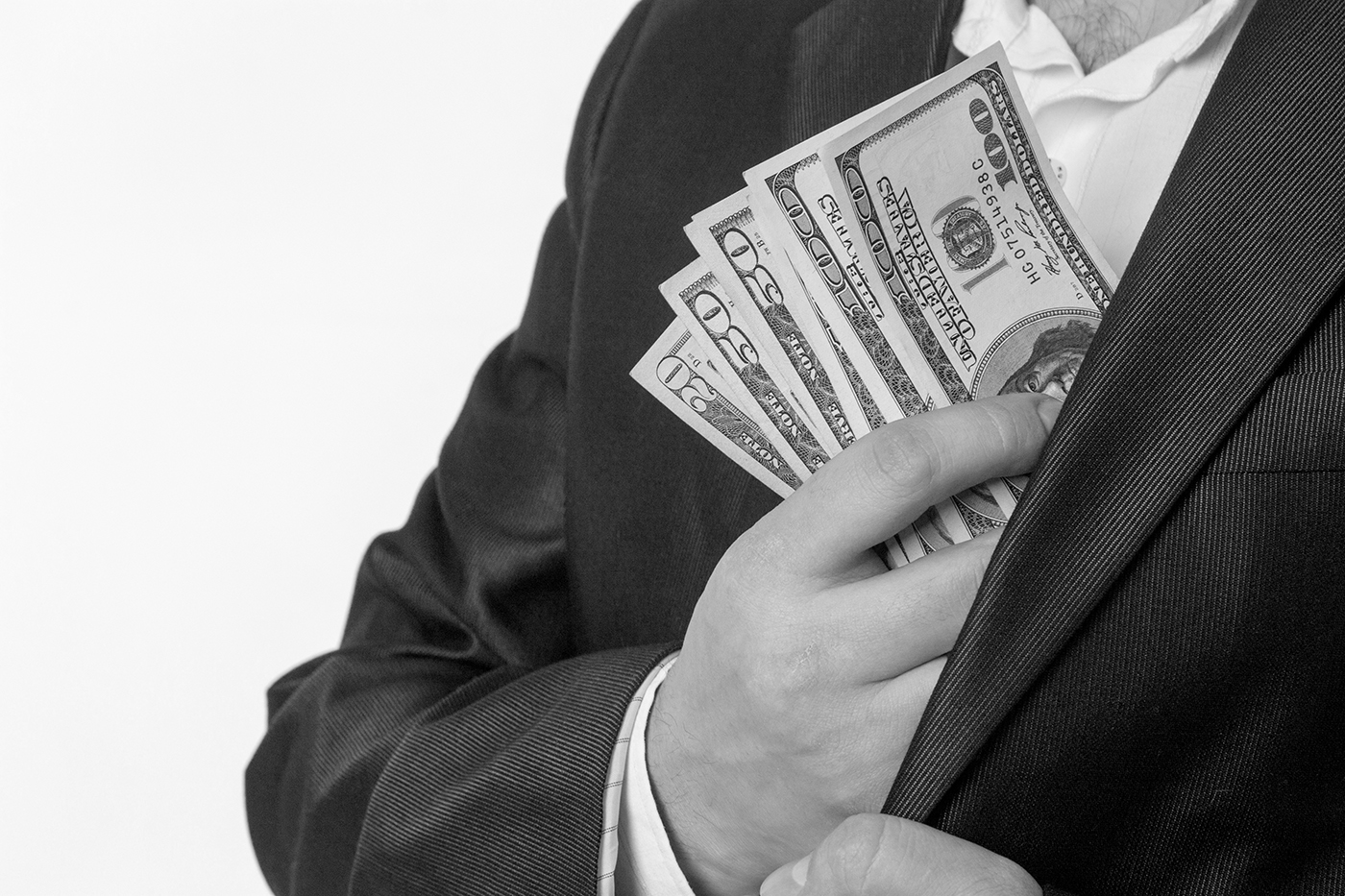 Businessman pocketing large bills