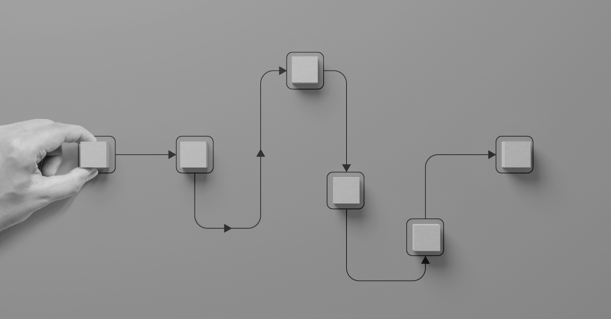 Hand holding wooden cube block arranging processing management on background